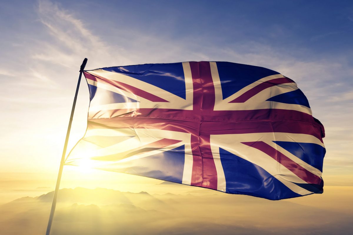 United Kingdom British english flag textile cloth fabric waving on the top sunrise mist fog U.K. Flag